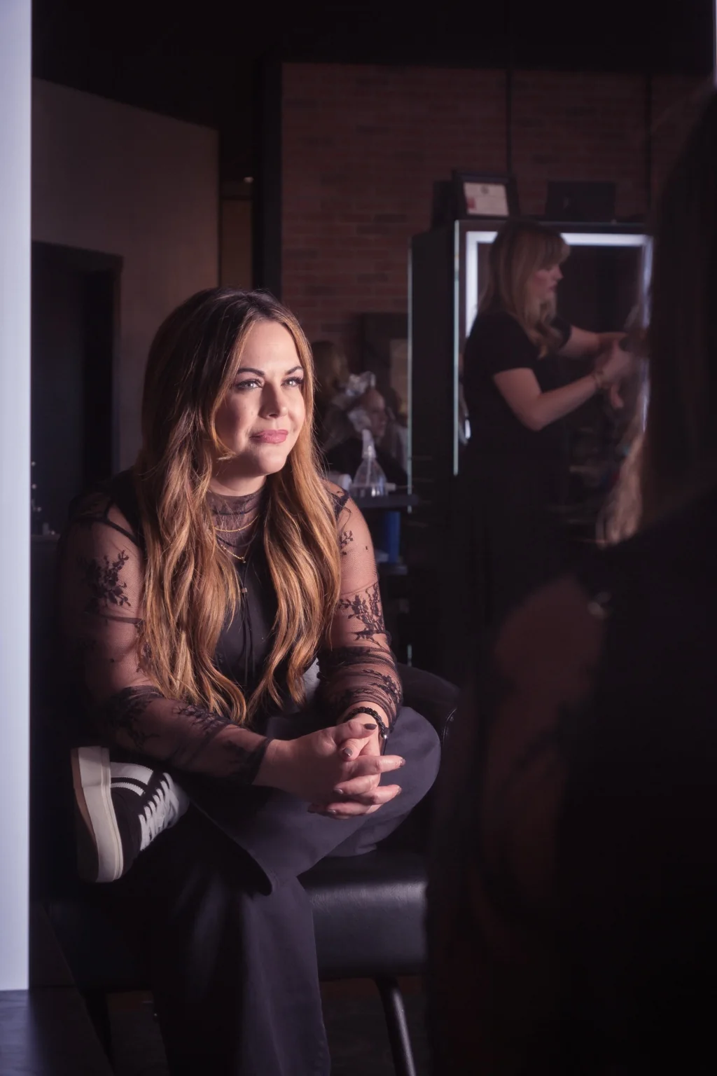 Lauren Nicole seated inside Fort Worth Hair and Co.